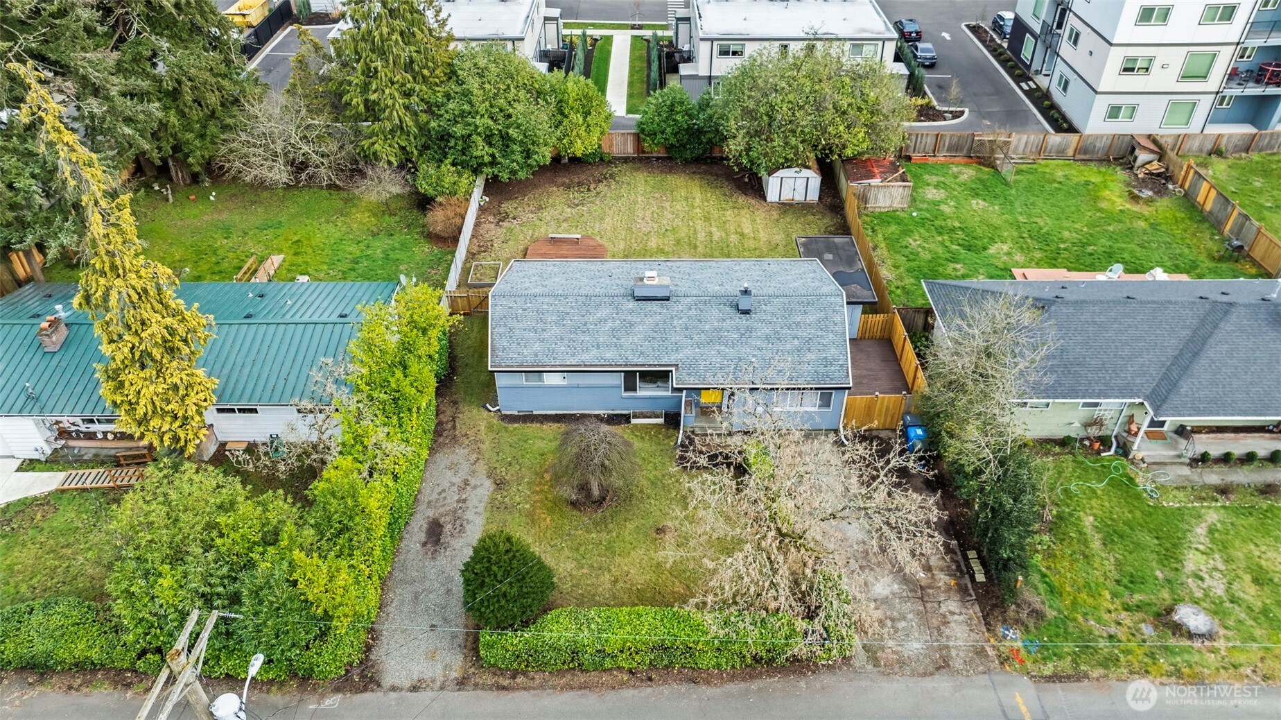 8809 Meadow Road Southwest Lakewood, WA 98499 - Photo 32 of 33 an aerial view of a house with garden space and a lake view