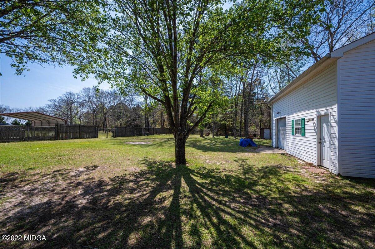 702 Harper Road Perry, GA 31069 - Photo 4 of 17 a view of backyard with large trees