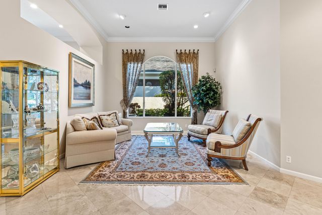 a living room with fireplace furniture and a large window