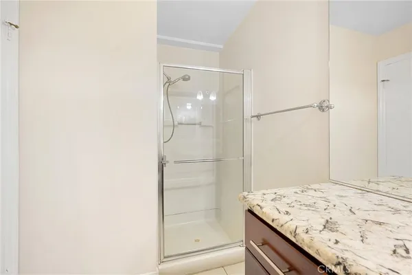 a bathroom with a shower and a sink