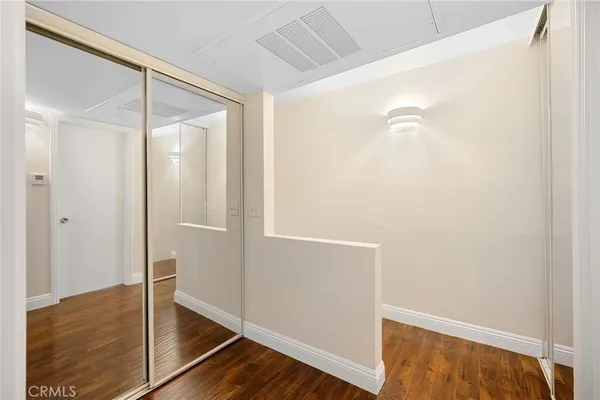 a view of a room with wooden floor