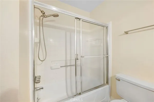 a bathroom with a glass shower door
