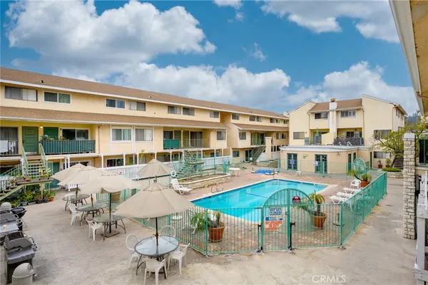 a view of a swimming pool with outdoor seating