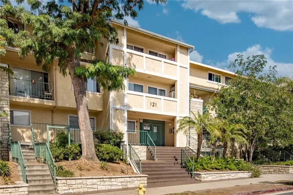 a front view of a multi story residential apartment building with a yard