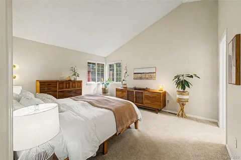 a bedroom with a bed and a couch
