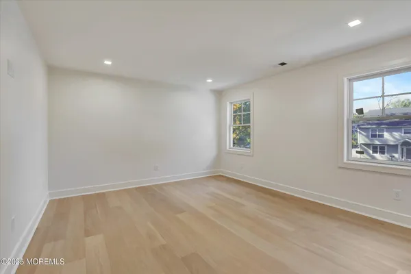 an empty room with windows and closet