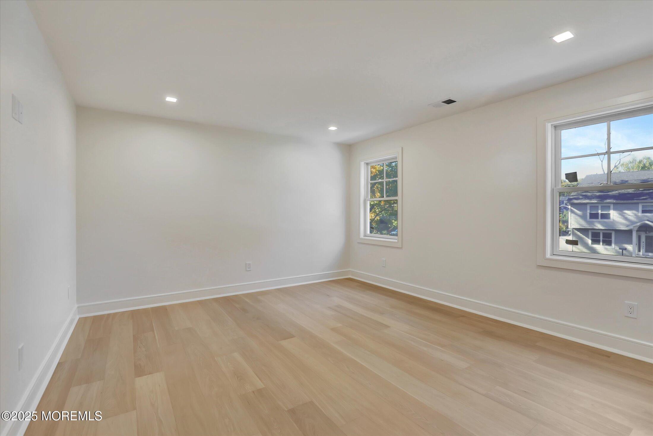 an empty room with windows and closet