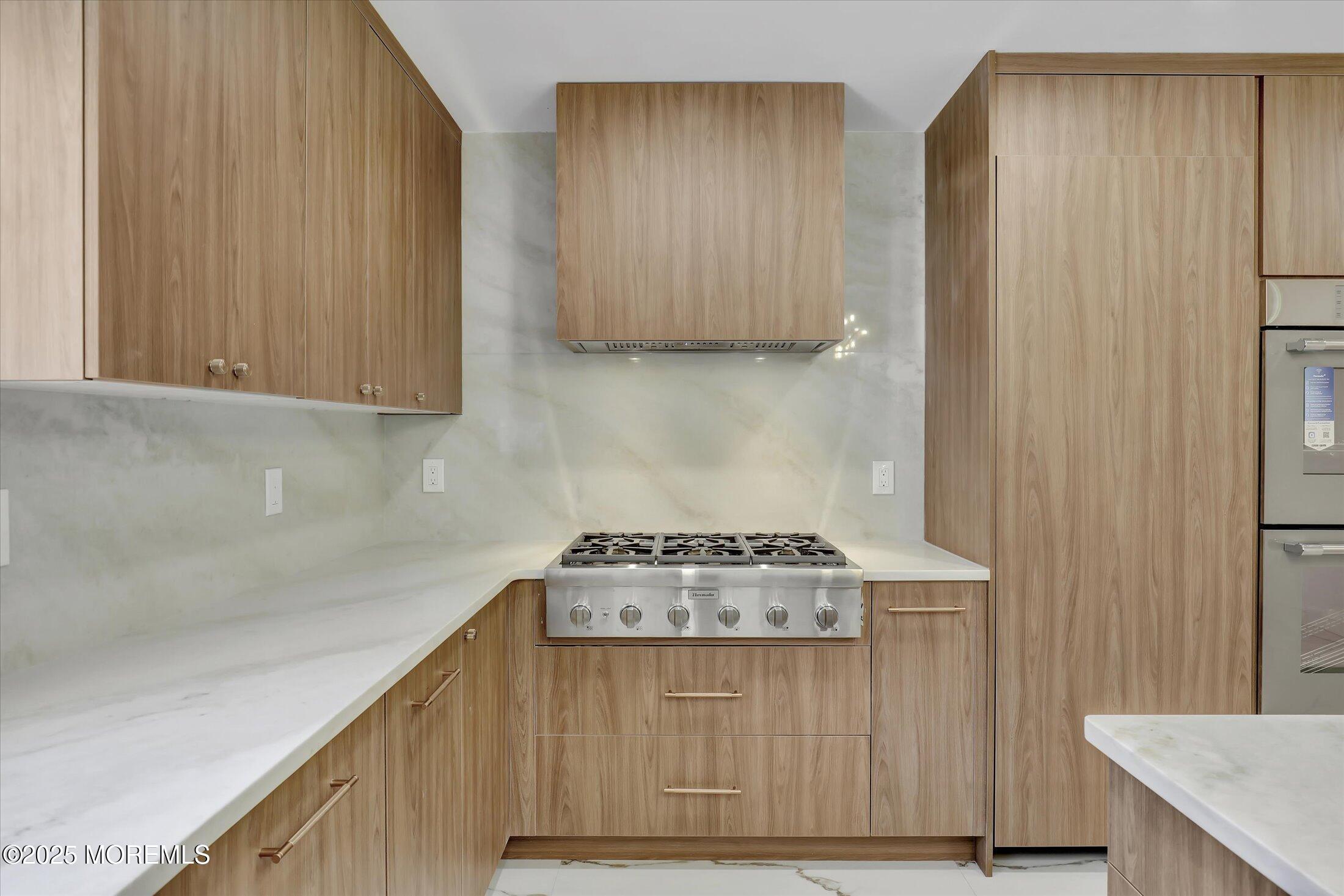243 Woodcrest Road Oakhurst, NJ 07755 - Photo 11 of 42 a kitchen with granite countertop cabinets and black appliances