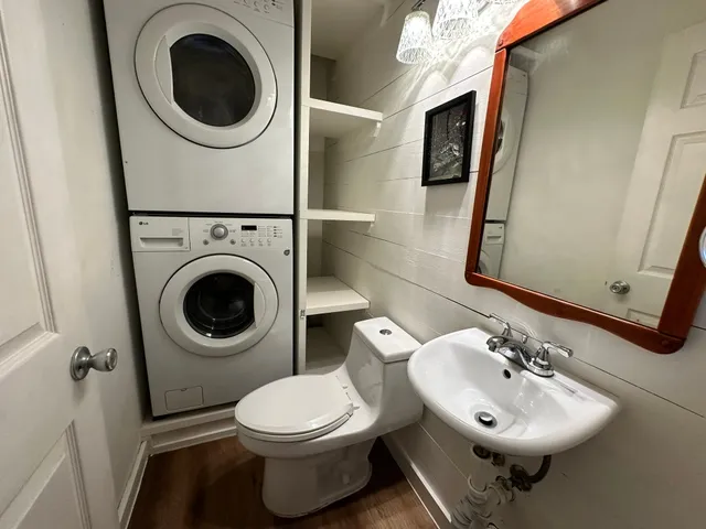 a bathroom with a sink mirror and toilet
