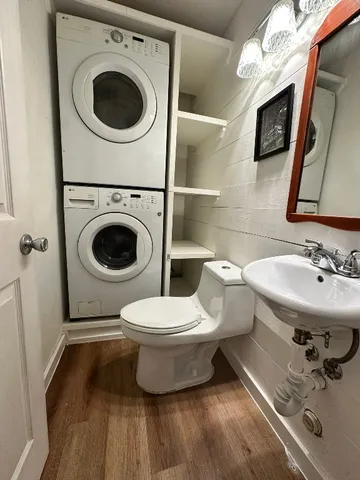 a bathroom with a toilet a sink and mirror