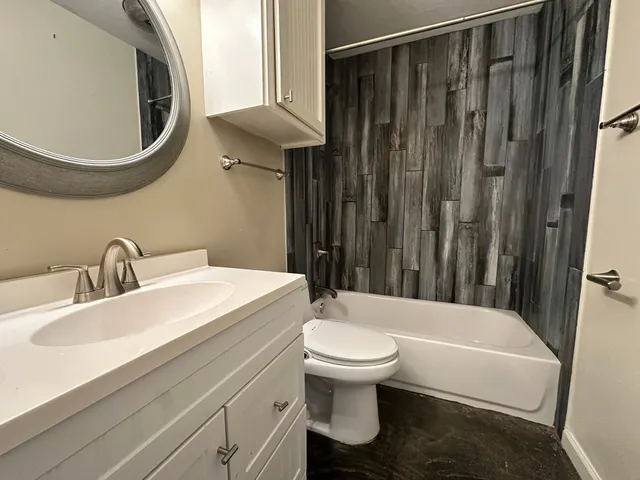 a bathroom with a toilet a sink and bathtub