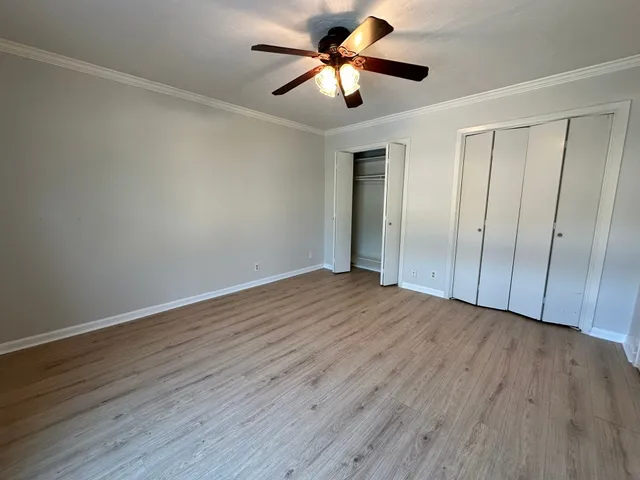 a view of empty room with wooden floor