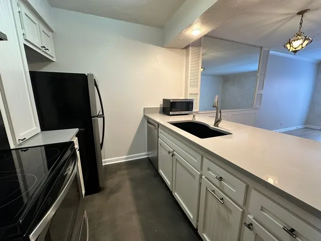 a kitchen with a sink and refrigerator