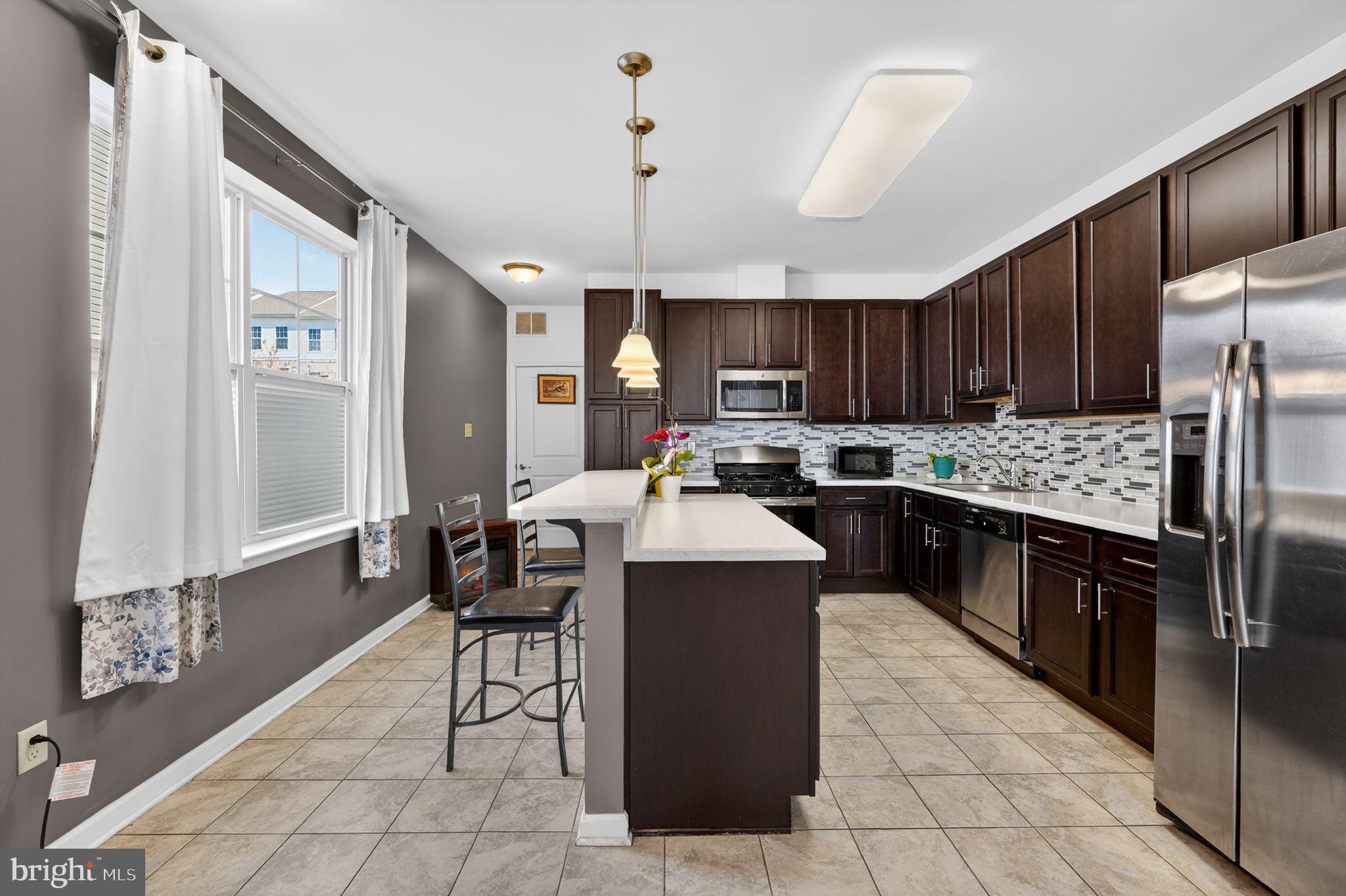 33 Rowand Way East Clementon, NJ 08021 - Photo 7 of 15 a kitchen with kitchen island granite countertop wooden cabinets a refrigerator oven a sink and dishwasher
