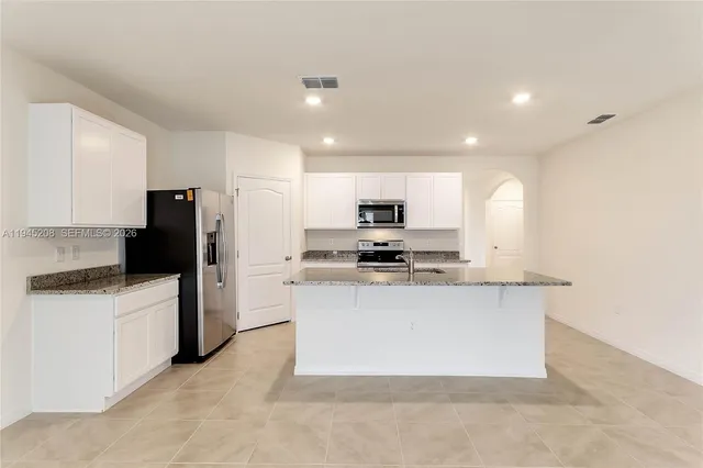 a kitchen with stainless steel appliances a refrigerator sink and stove