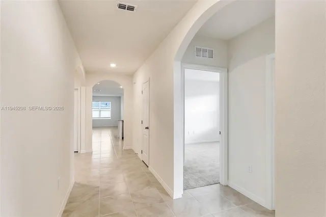 a view of a hallway with wooden shelves