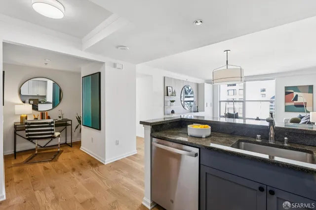 a kitchen that has a sink and a stove in it