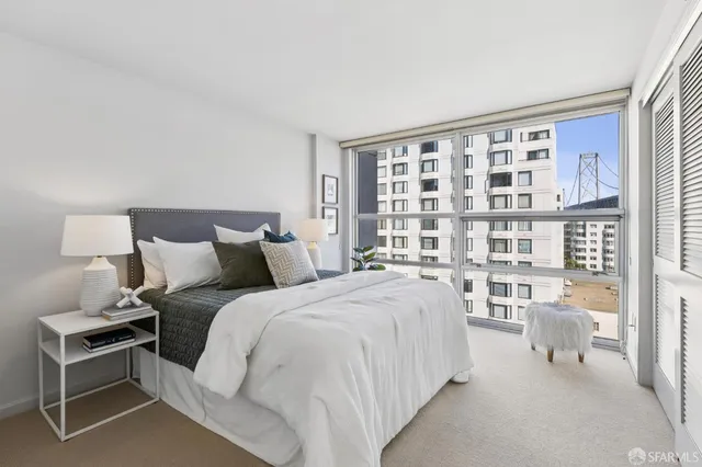 a bed room with a bed and a chair