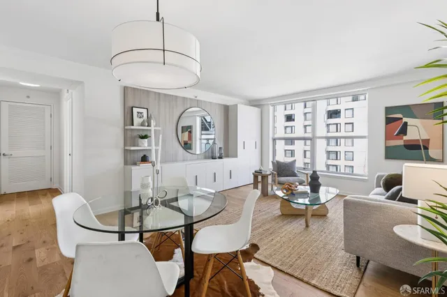 a living room with furniture a dining table and a bookshelf