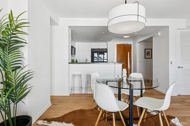 a view of a dining room with furniture and wooden floor