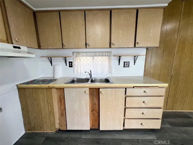 a view of cabinets a wooden floor and a window
