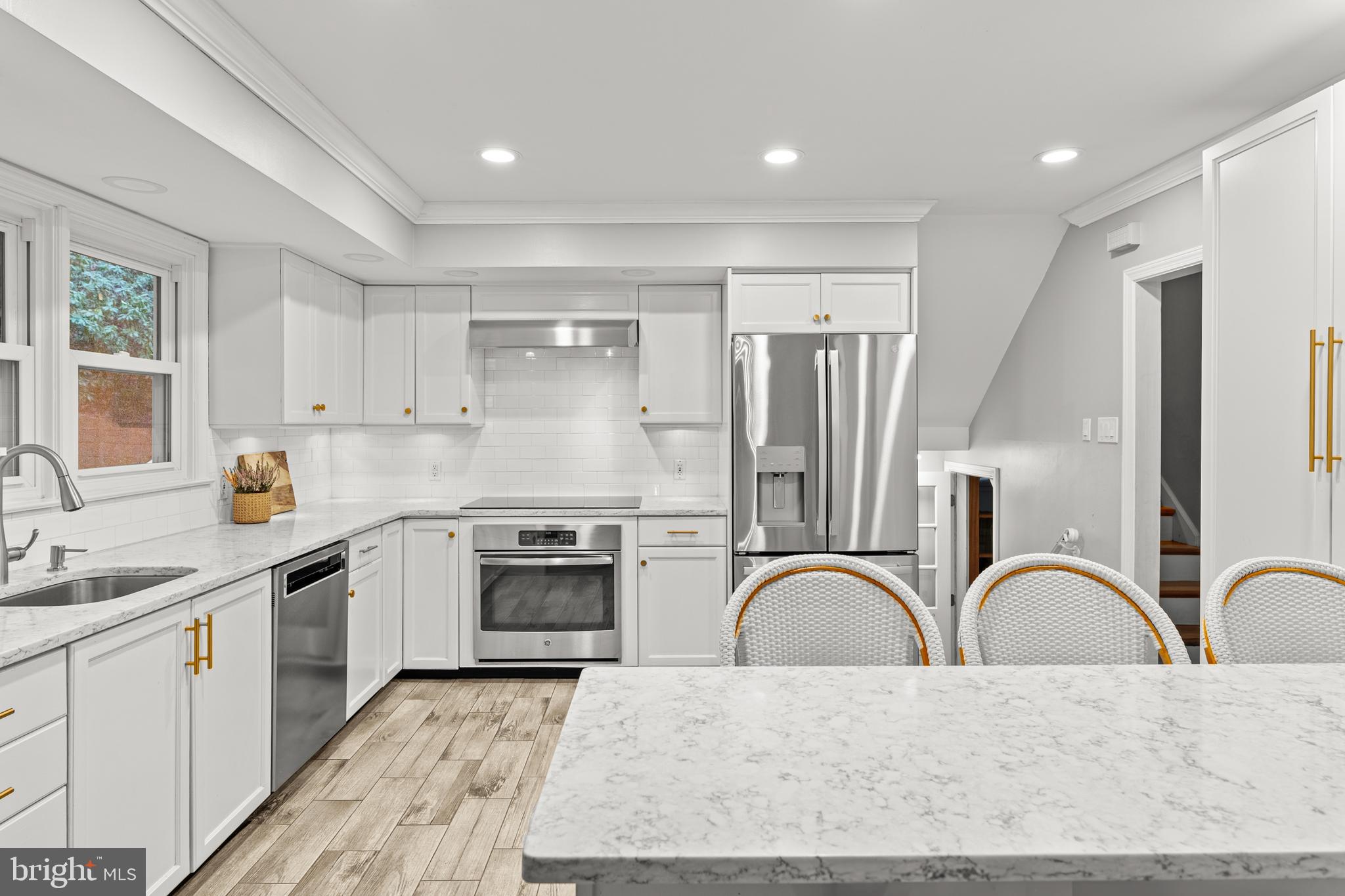 476 Upper Weadley Road Wayne, PA 19087 - Photo 14 of 45 a kitchen with stainless steel appliances granite countertop a stove top oven a sink a kitchen island with stainless steel appliances and cabinets