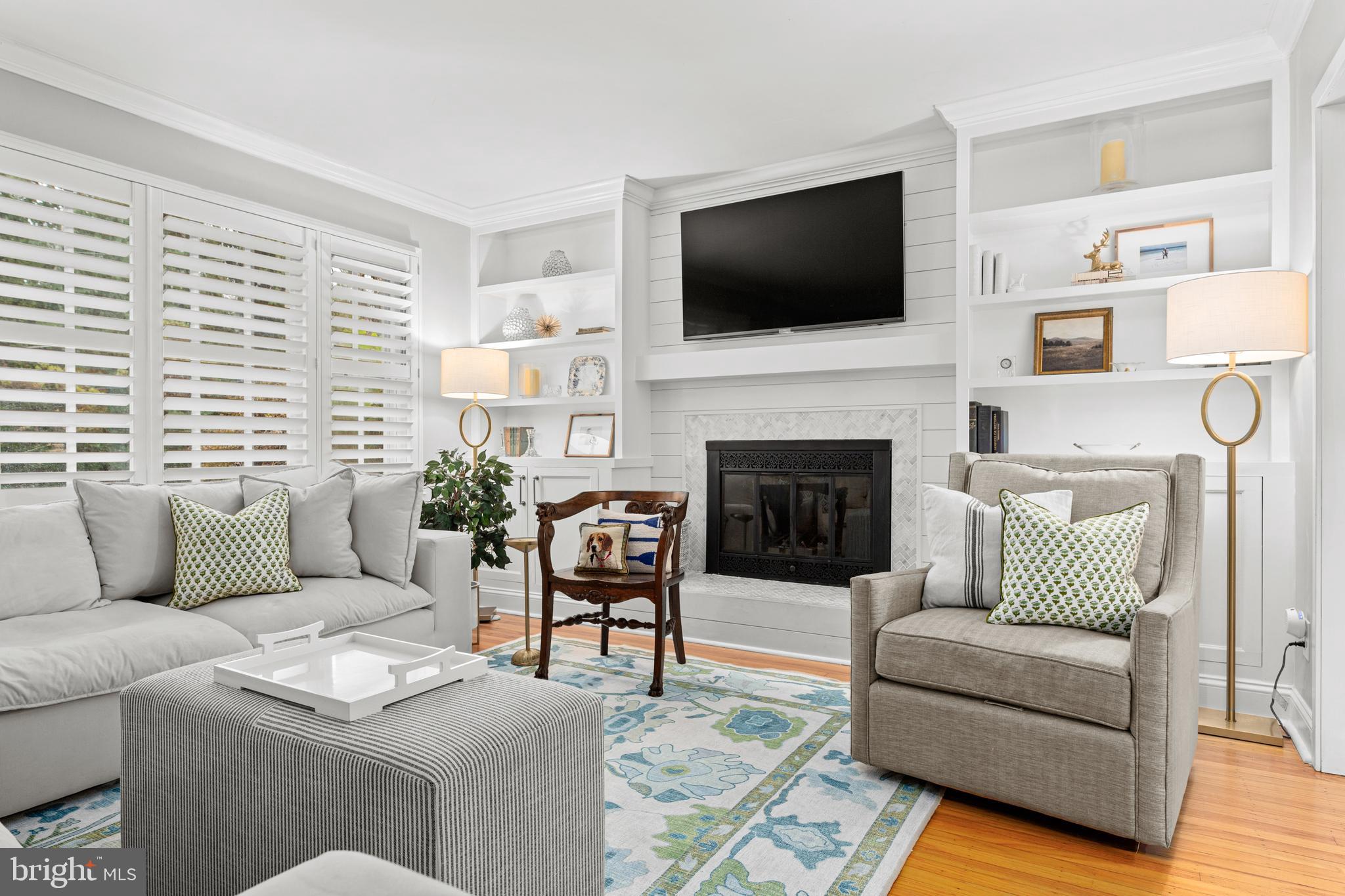 476 Upper Weadley Road Wayne, PA 19087 - Photo 8 of 45 a living room with furniture a flat screen tv and a fireplace