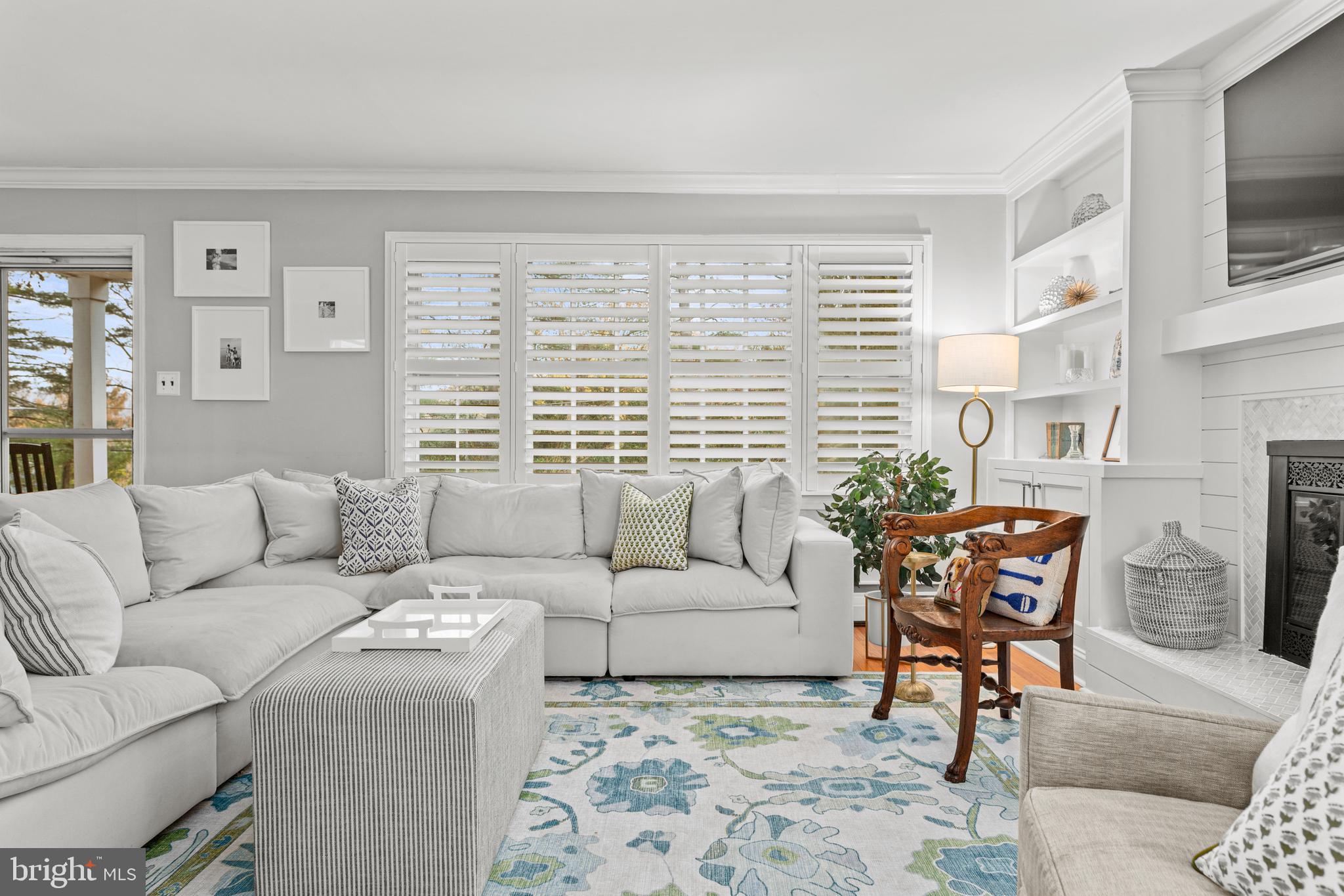 476 Upper Weadley Road Wayne, PA 19087 - Photo 10 of 45 a living room with furniture a fireplace and a flat screen tv