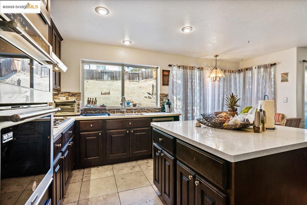 4137 Amargosa Drive Antioch, CA 94531 - Photo 13 of 31 a kitchen with a stove sink and cabinets