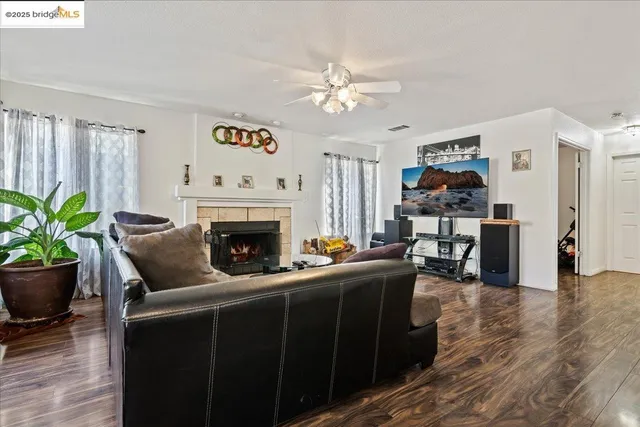 a living room with furniture a fireplace and a window