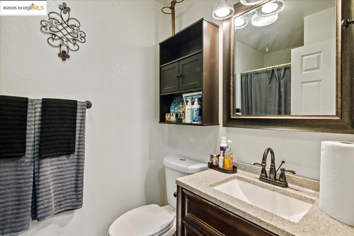 4137 Amargosa Drive Antioch, CA 94531 - Photo 17 of 31 a bathroom with a sink a toilet and mirror