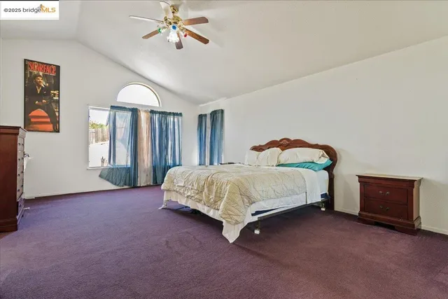 a spacious bedroom with a bed and a dresser