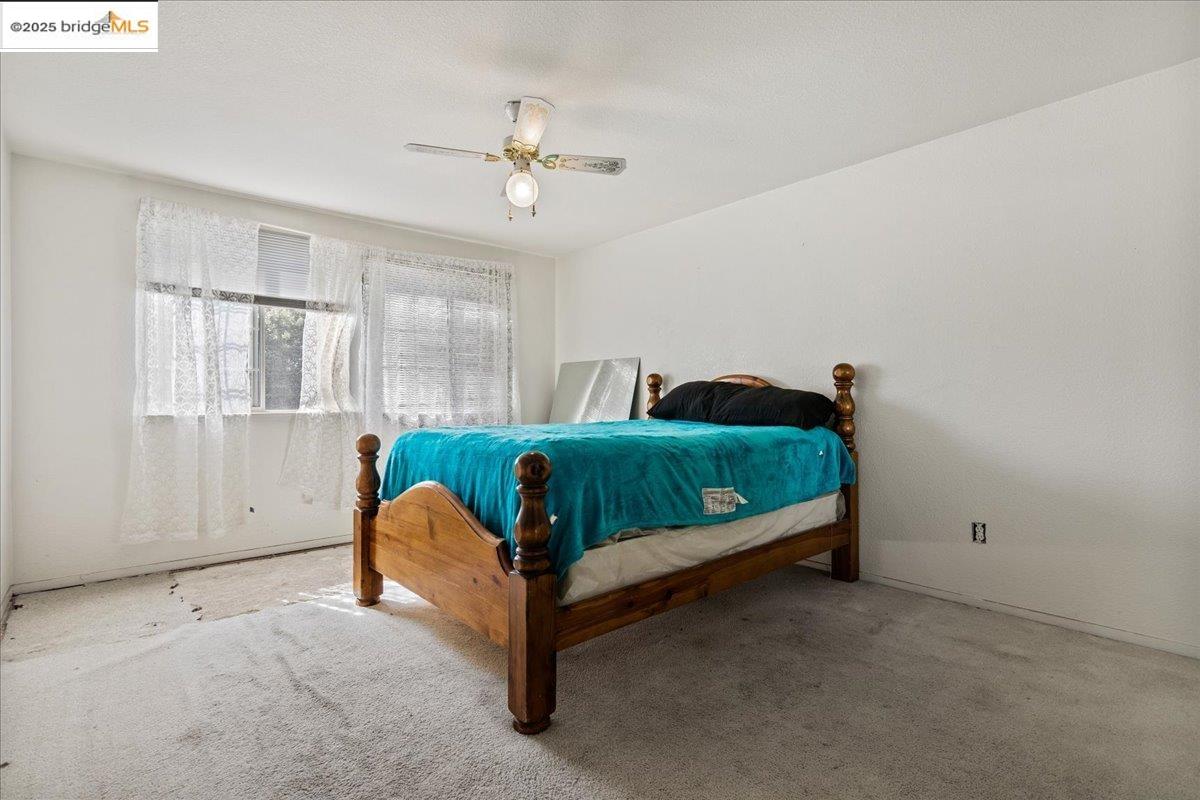 4137 Amargosa Drive Antioch, CA 94531 - Photo 24 of 31 a bedroom with a bed and a chandelier