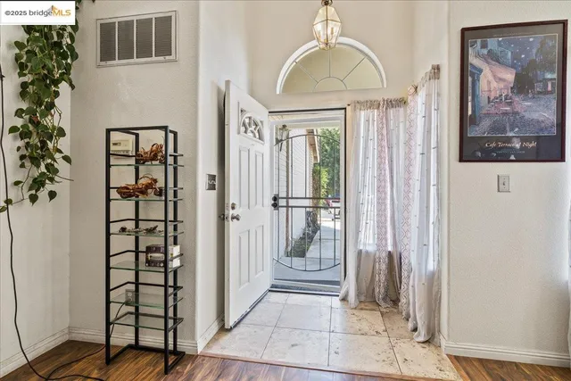a view of a hallway with wooden floor and windows