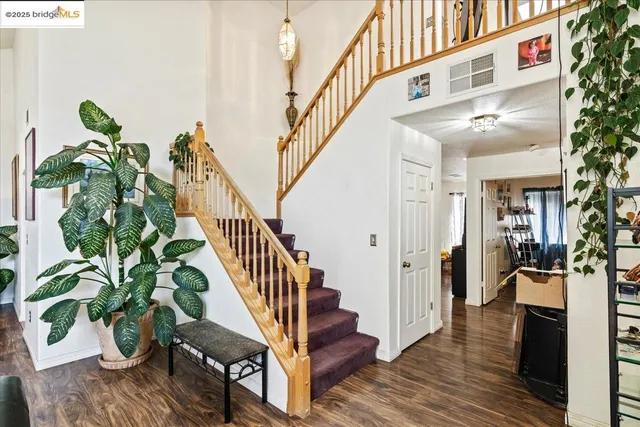 a view of entryway and hall with wooden floor