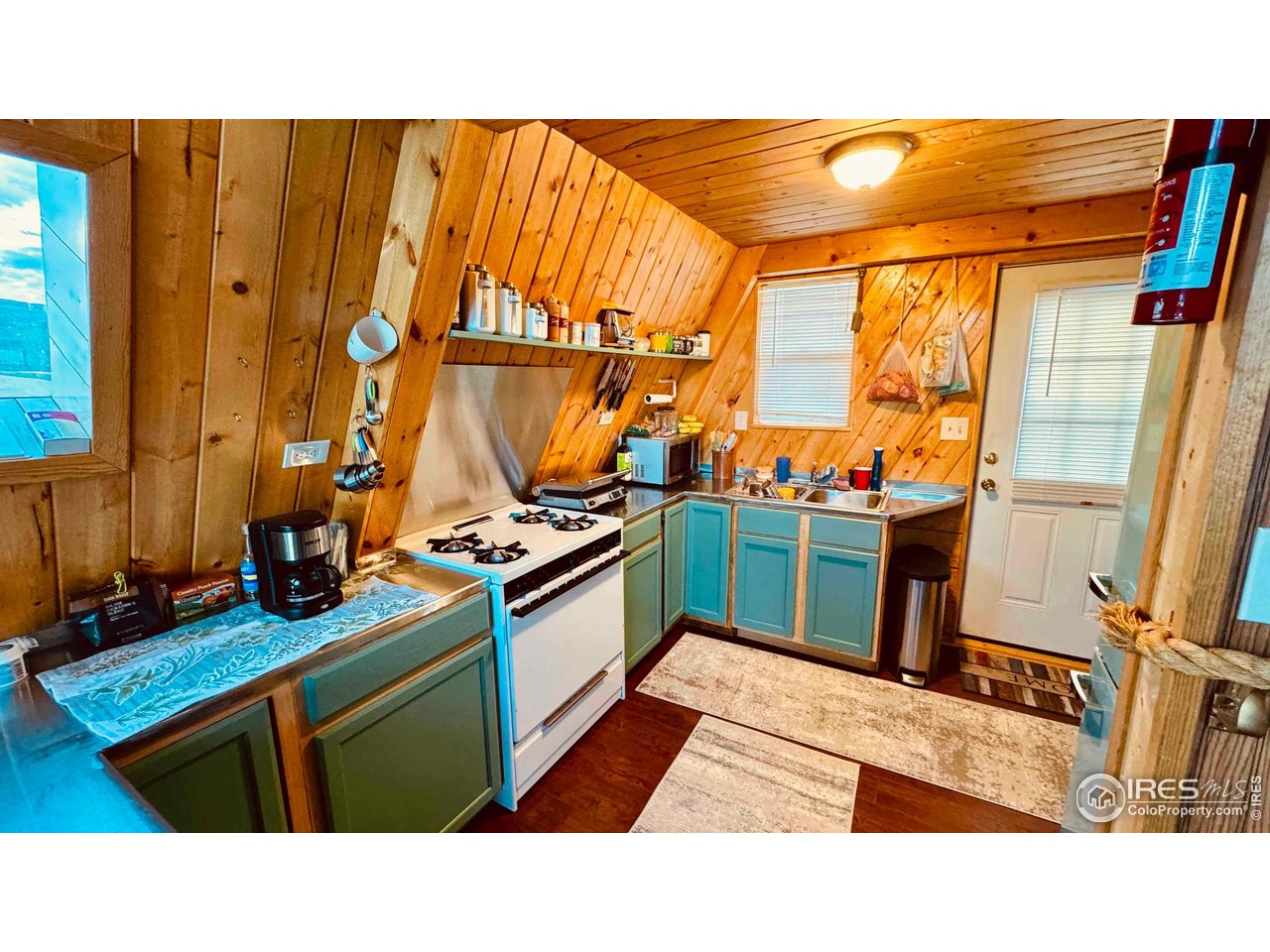 867 Windy Ridge Road Livermore, CO 80536 - Photo 7 of 23 a kitchen with stainless steel appliances kitchen island granite countertop a sink and a refrigerator