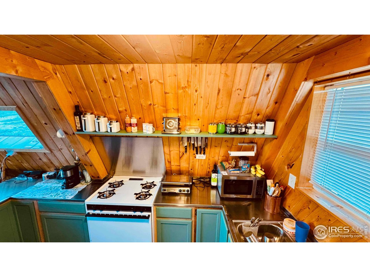 867 Windy Ridge Road Livermore, CO 80536 - Photo 9 of 23 a balcony with a table and chairs