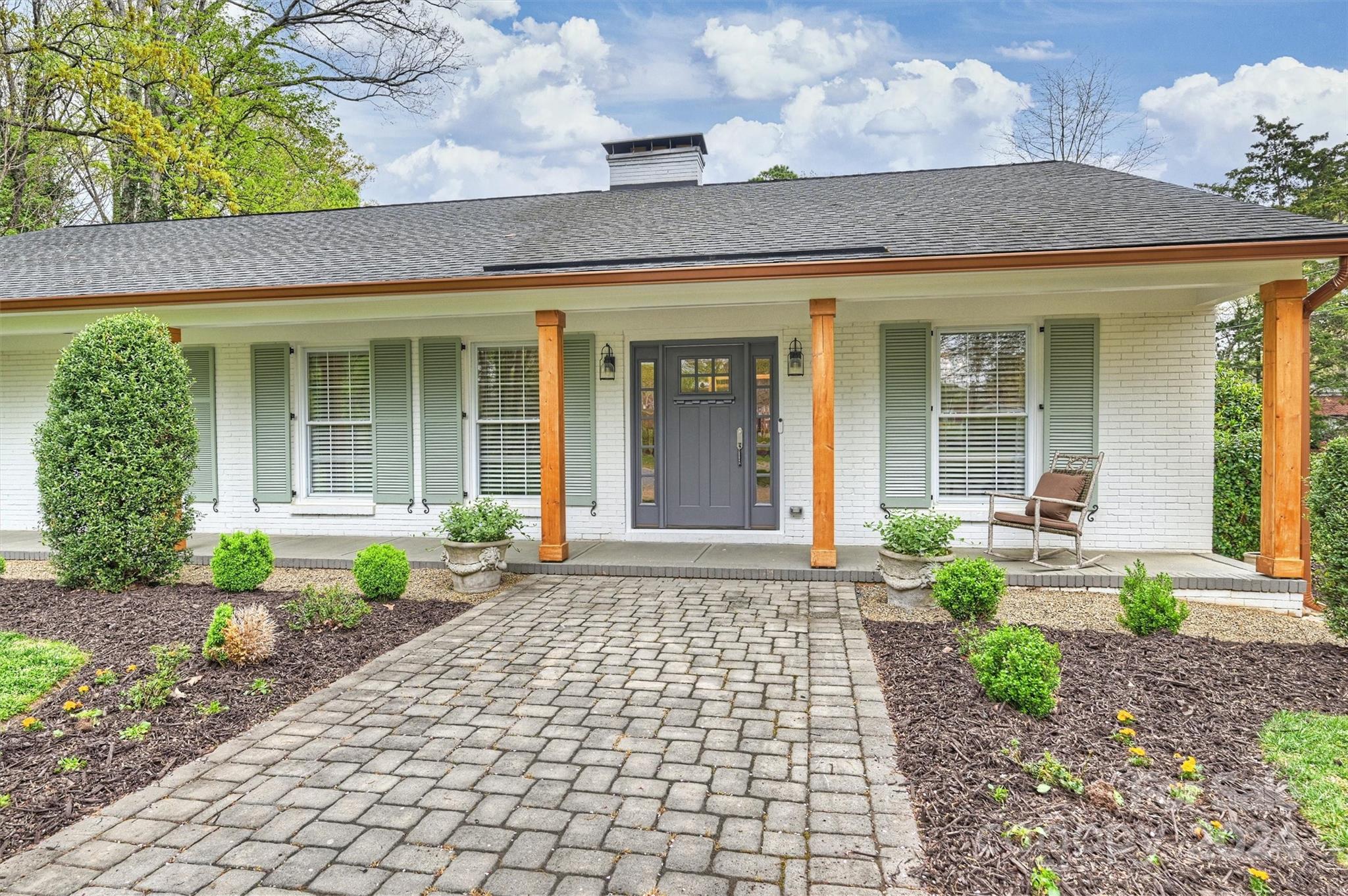 a front view of a house with garden