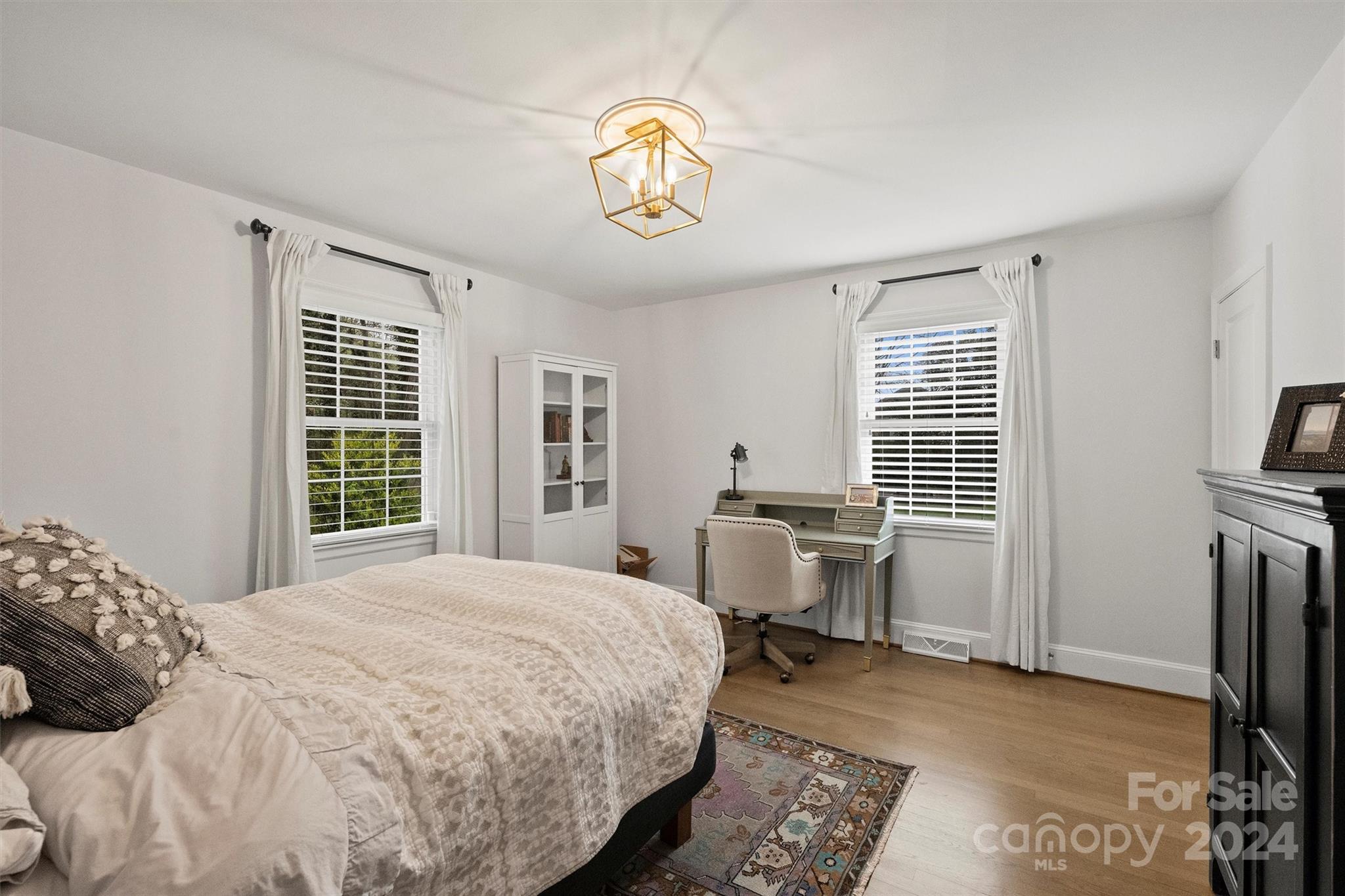 101 Sardis View Road Charlotte, NC 28211 - Photo 24 of 43 a bedroom with a bed and a chandelier