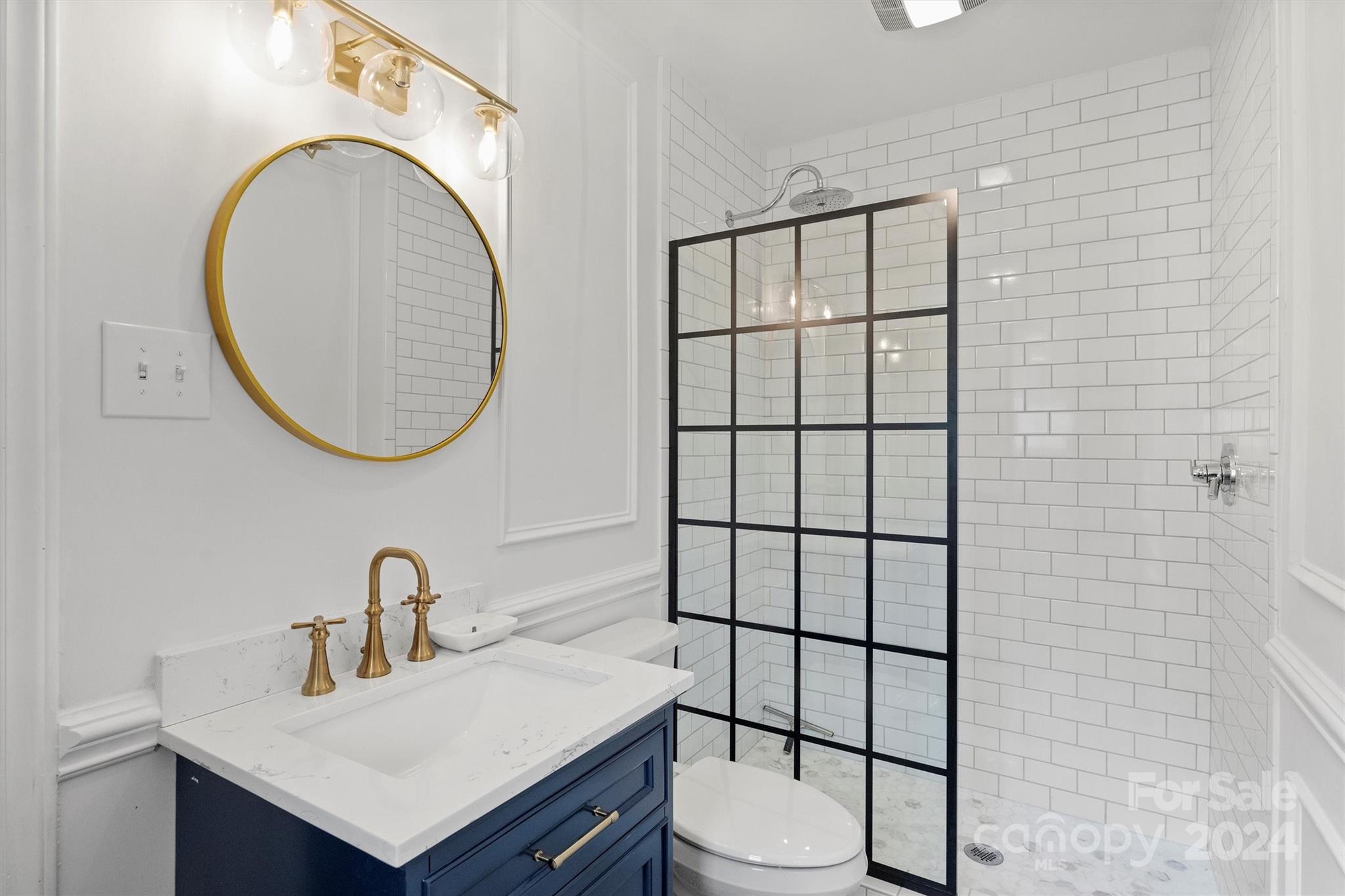 101 Sardis View Road Charlotte, NC 28211 - Photo 28 of 43 a bathroom with a sink a toilet and a mirror