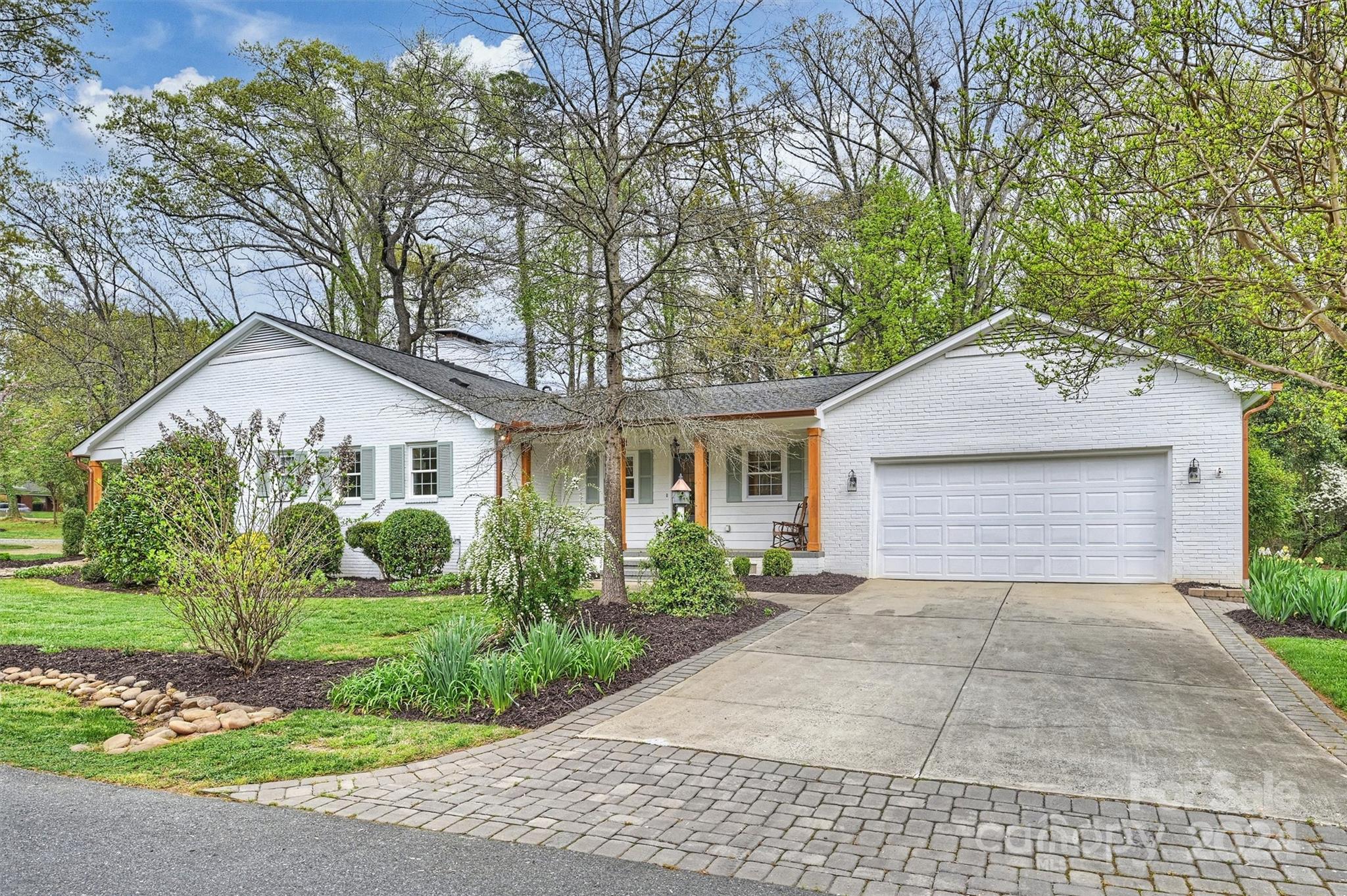 101 Sardis View Road Charlotte, NC 28211 - Photo 42 of 43 front view of a house with a yard and potted plants