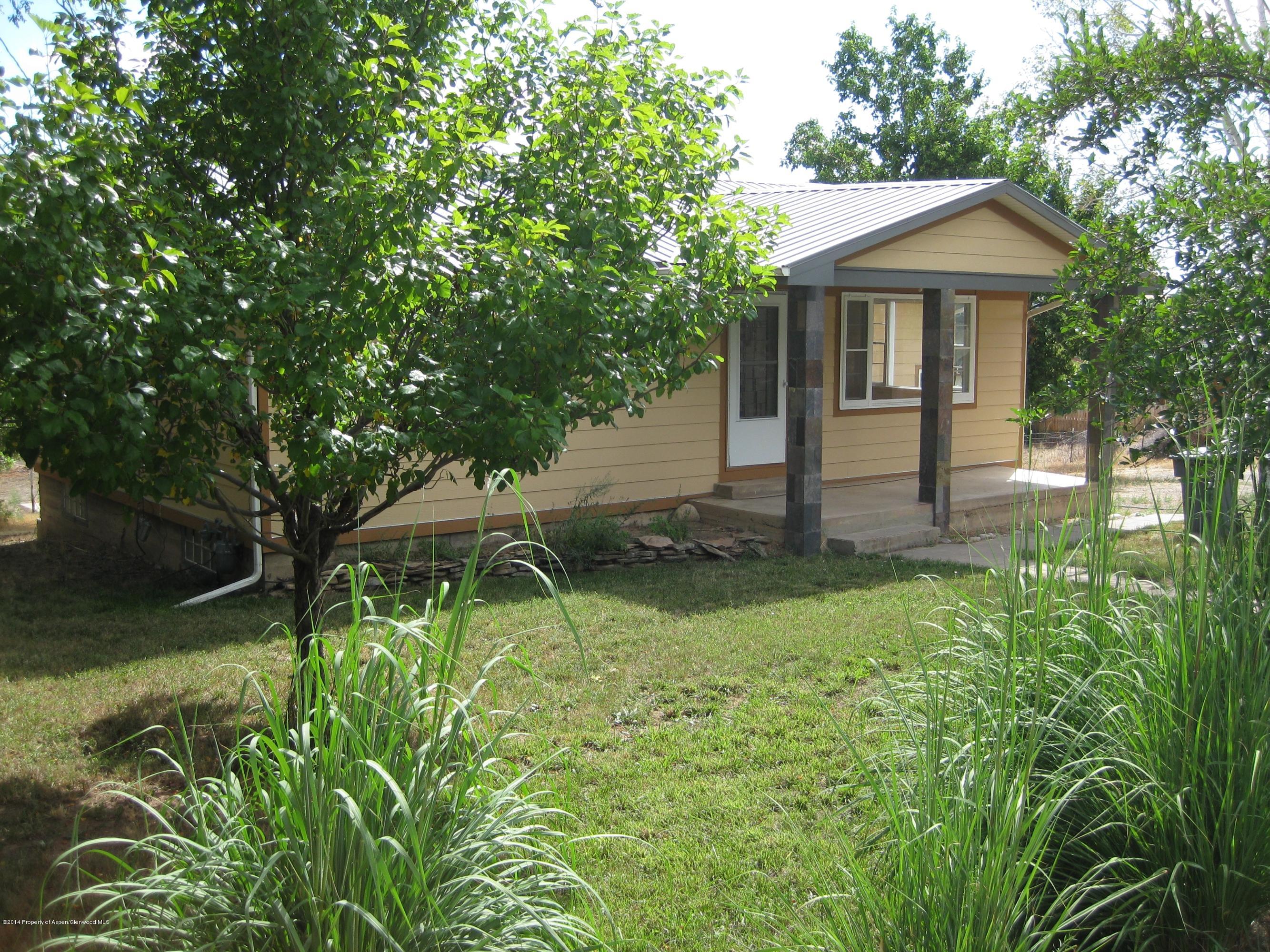 653 East 7th Street Rifle, CO 81650 - Photo 1 of 16 a front view of a house with garden