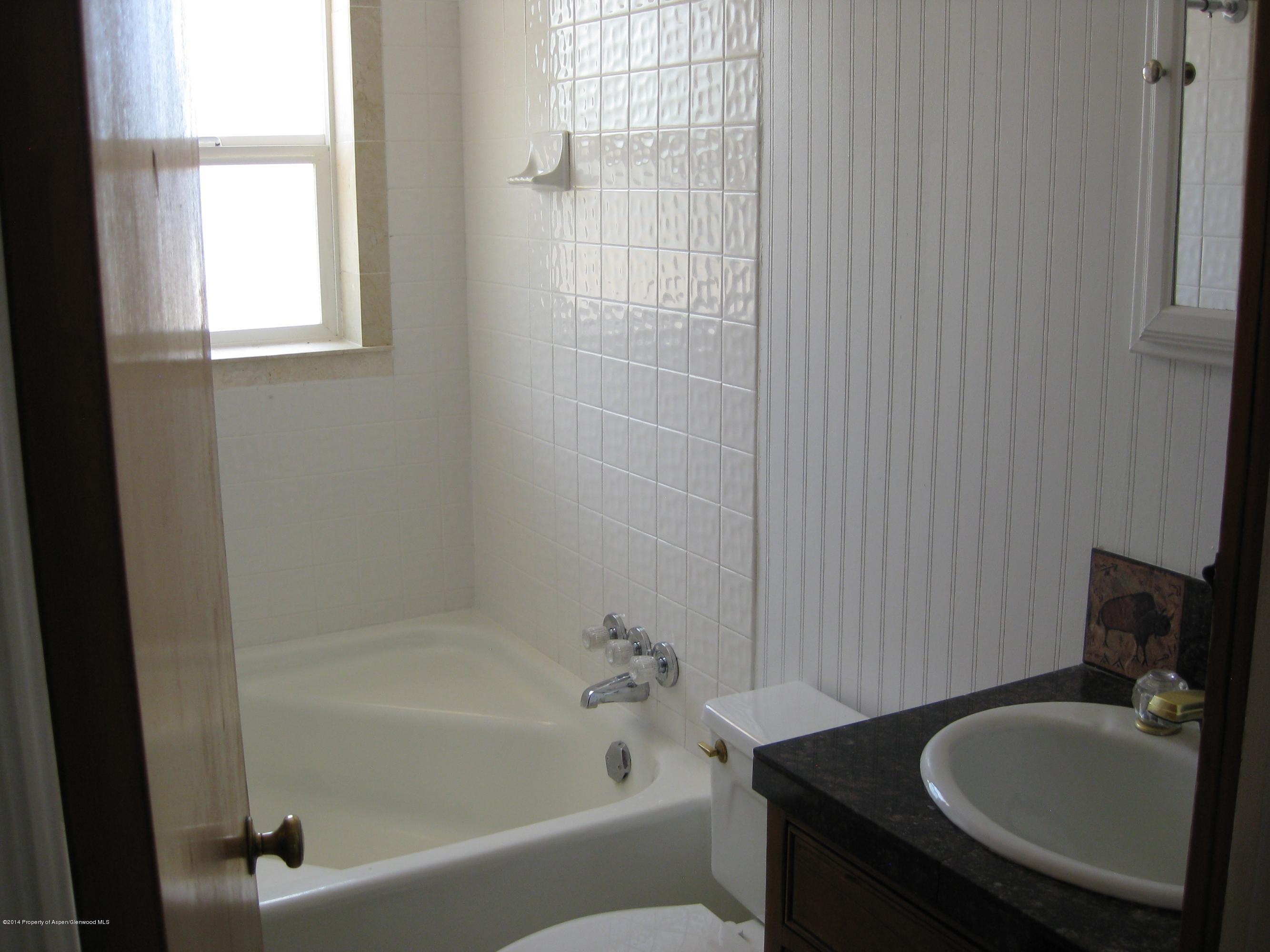 653 East 7th Street Rifle, CO 81650 - Photo 15 of 16 a bathroom with a bathtub and a sink