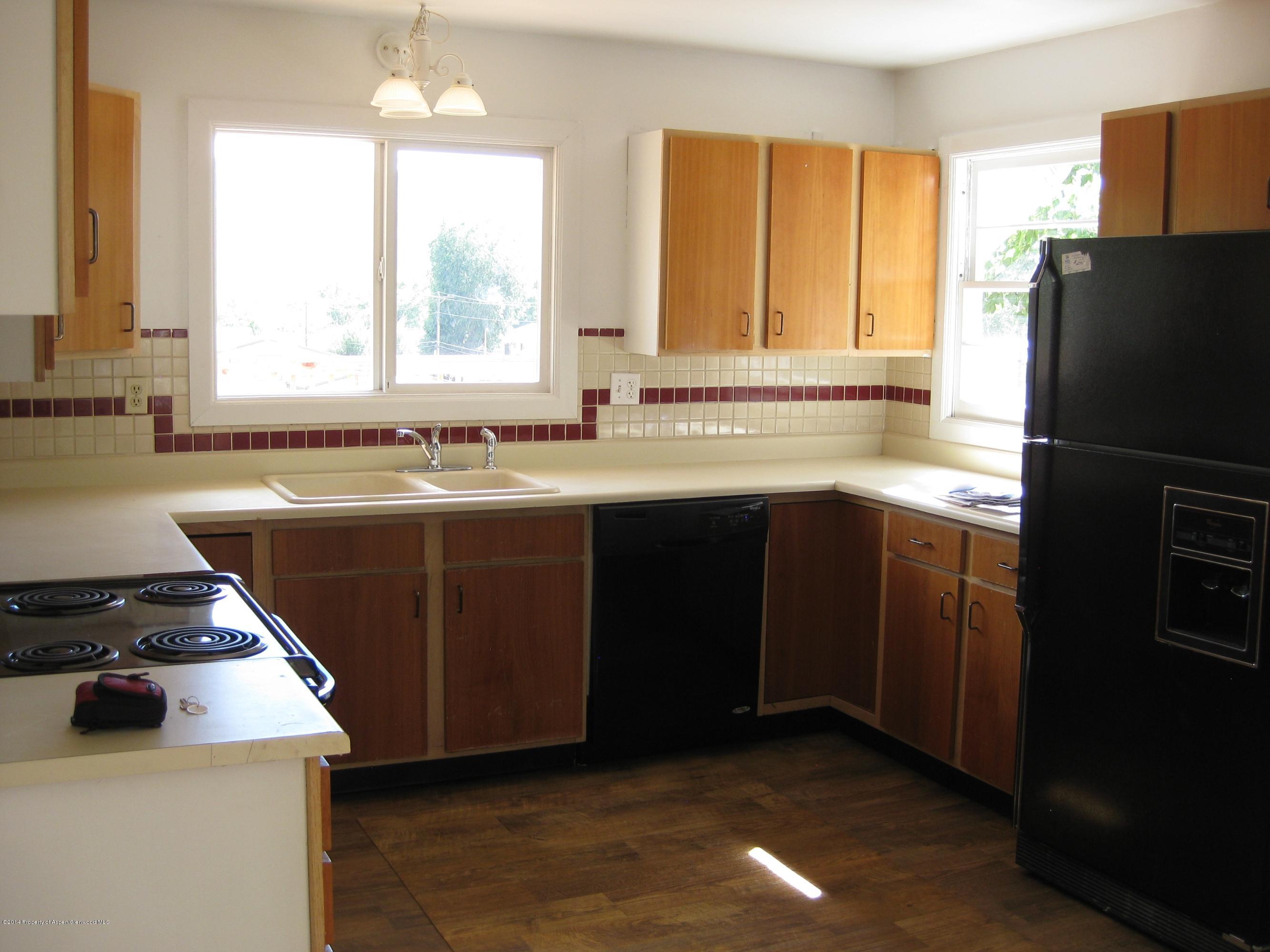 653 East 7th Street Rifle, CO 81650 - Photo 3 of 16 a kitchen with a sink stove and refrigerator