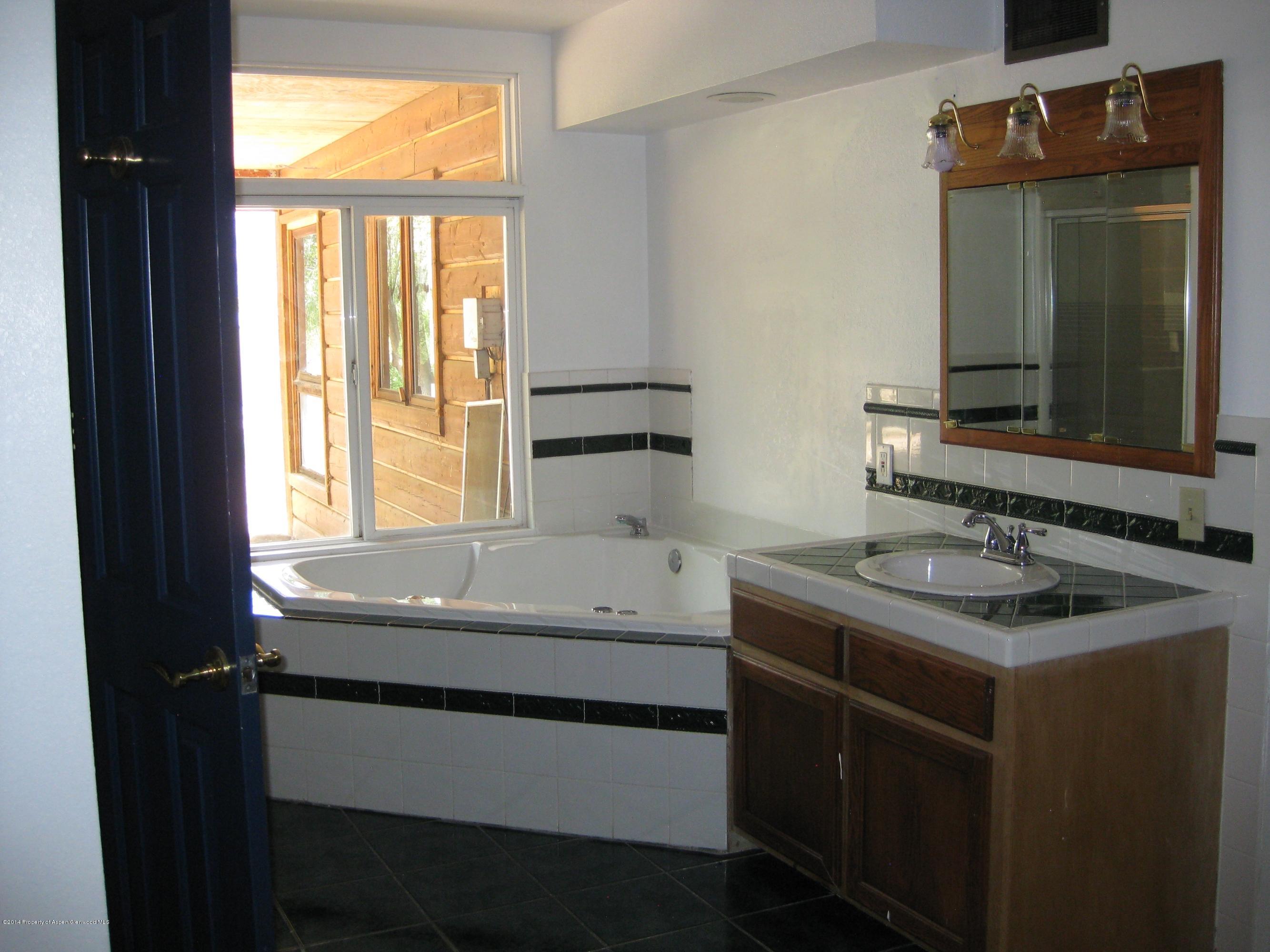 653 East 7th Street Rifle, CO 81650 - Photo 6 of 16 a bathroom with a sink and a mirror
