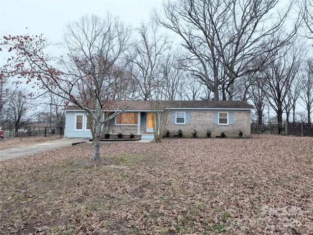 a large house with a large tree in front of a house