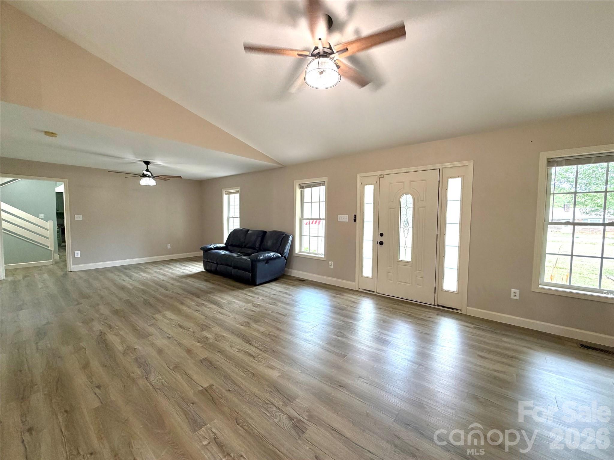 1027 Tabor Road Olin, NC 28660 - Photo 8 of 43 a view of a livingroom with a ceiling fan and wooden floor