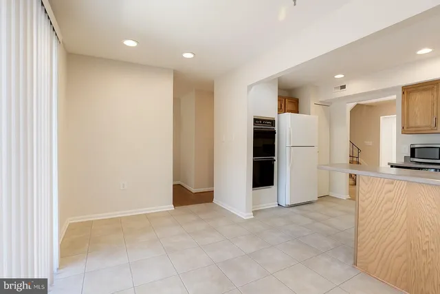 a view of a kitchen with a refrigerator and a sink