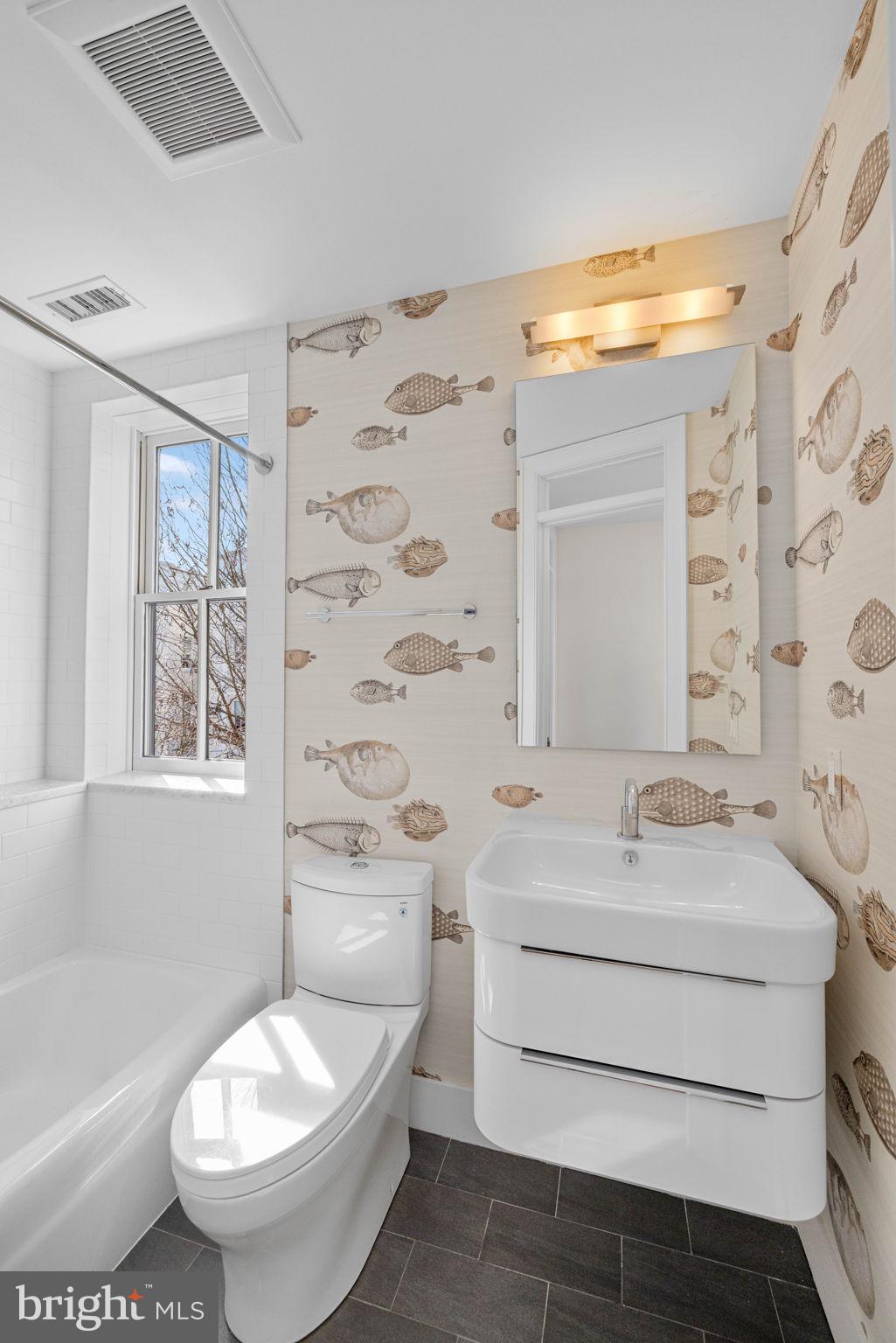 2912 Dumbarton Street Northwest Washington, DC 20007 - Photo 14 of 22 a bathroom with a sink toilet a mirror and shower