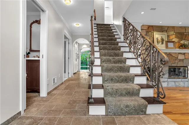 an empty room with a chandelier fan and windows